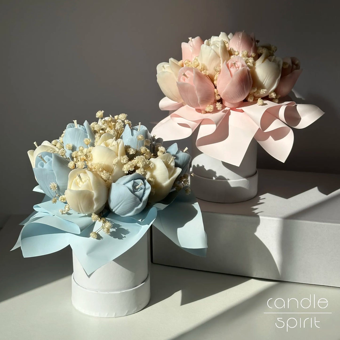 Two blue and pink flower bouquets of tulip candles in a white boxes - pastel Easter decor, unique baby shower gift