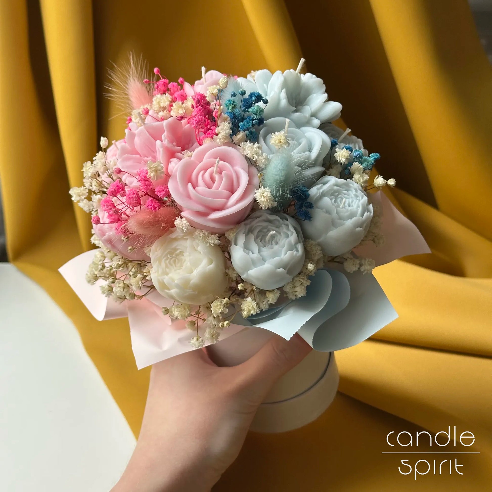 Candle bouquet of pink, white, and blue flowers held by a hand - romantic Valentine's Day gift for a wife, woman