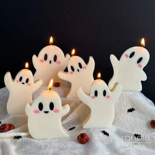 Cute ghost candles with lit flames - cozy autumn decor, fall scented Halloween candles, and baby shower favors