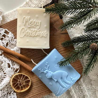 Two Christmas candles, one white with 'Merry Christmas' text and the other blue with a funny reindeer - unique gag gift, Secret Santa present 