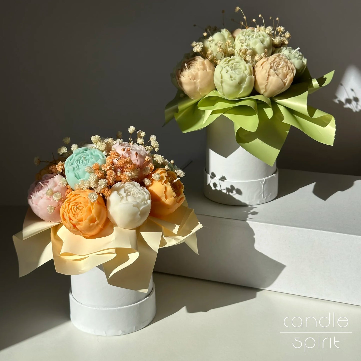 Two pastel floral bouquets of peony candles in white flower boxes - personalised wax anniversary gift for a wife, partner, girlfriend. Luxury Mother's Day gift.