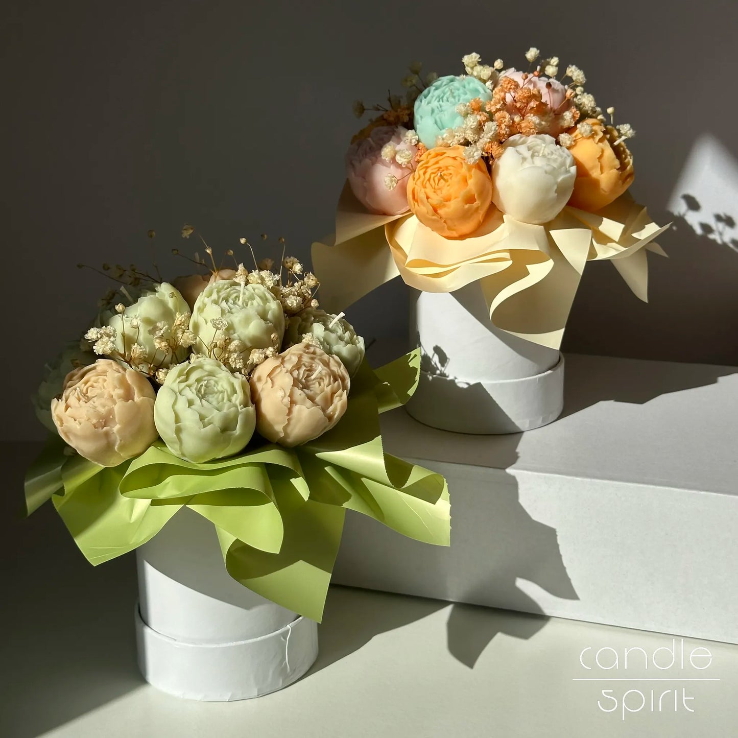 Two pastel bouquets of peony flower candles in white flower boxes - floral arrangement & wax anniversary gift for a wife.