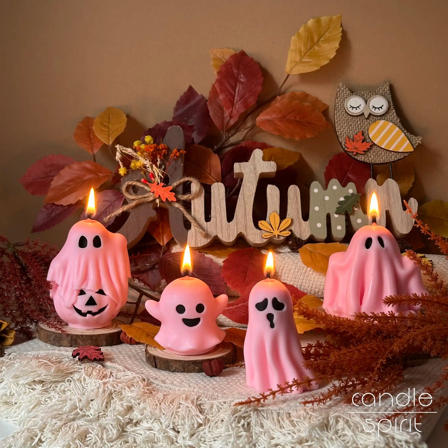 Pink ghost candles with autumn decorations - spooky Halloween decor and autumn holiday gifts for friends, kids, trick-or-treaters, coworkers, and party hosts.