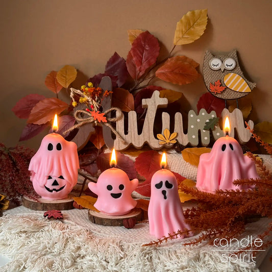 Pink ghost candles with autumn decorations - spooky Halloween decor and autumn holiday gifts for friends, kids, trick-or-treaters, coworkers, and party hosts.