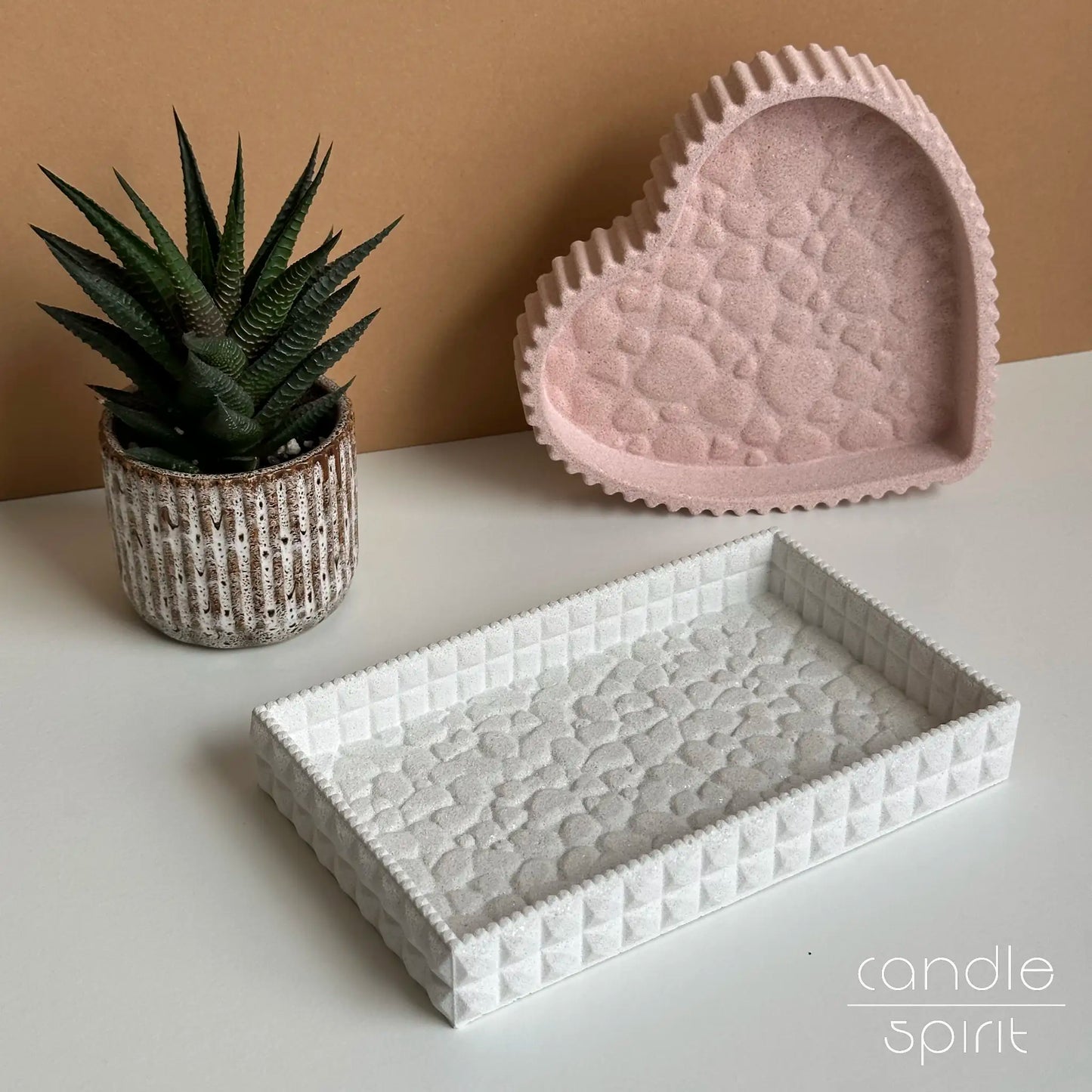 Textured rectangular and heart trinket bowls, one pink, one white - perfect for keeping jewelry, earrings, rings, watches, perfume, keys, skincare, and documents organised