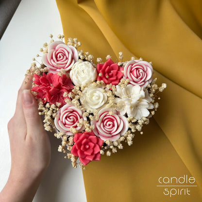 Heart-shaped arrangement of red, white, and pink flower candles held by a hand - touching Mother's Day gift for a mom
