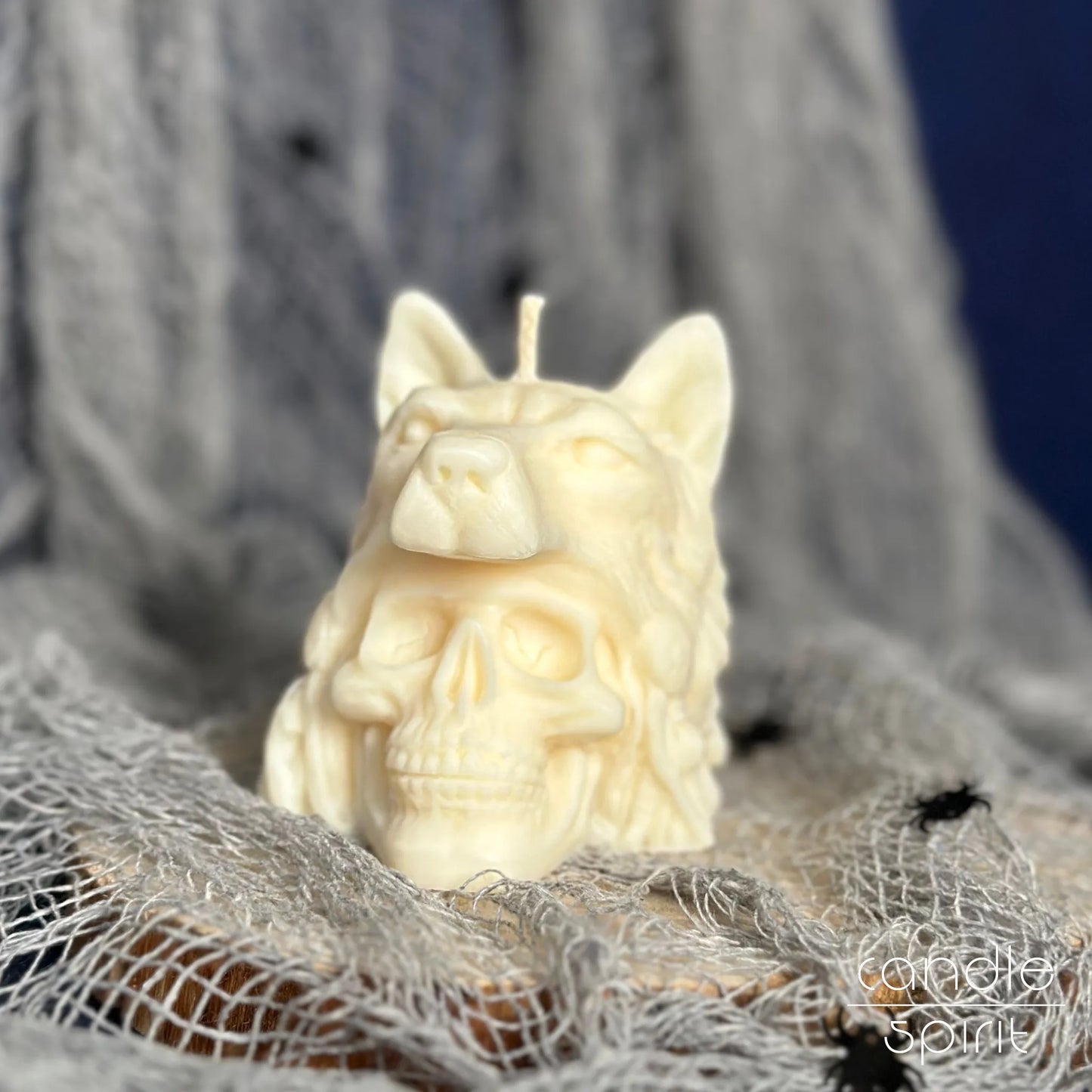 Scented white candle shaped like a human skull with a wolf on Halloween decoration - gothic birthday gift for a friend