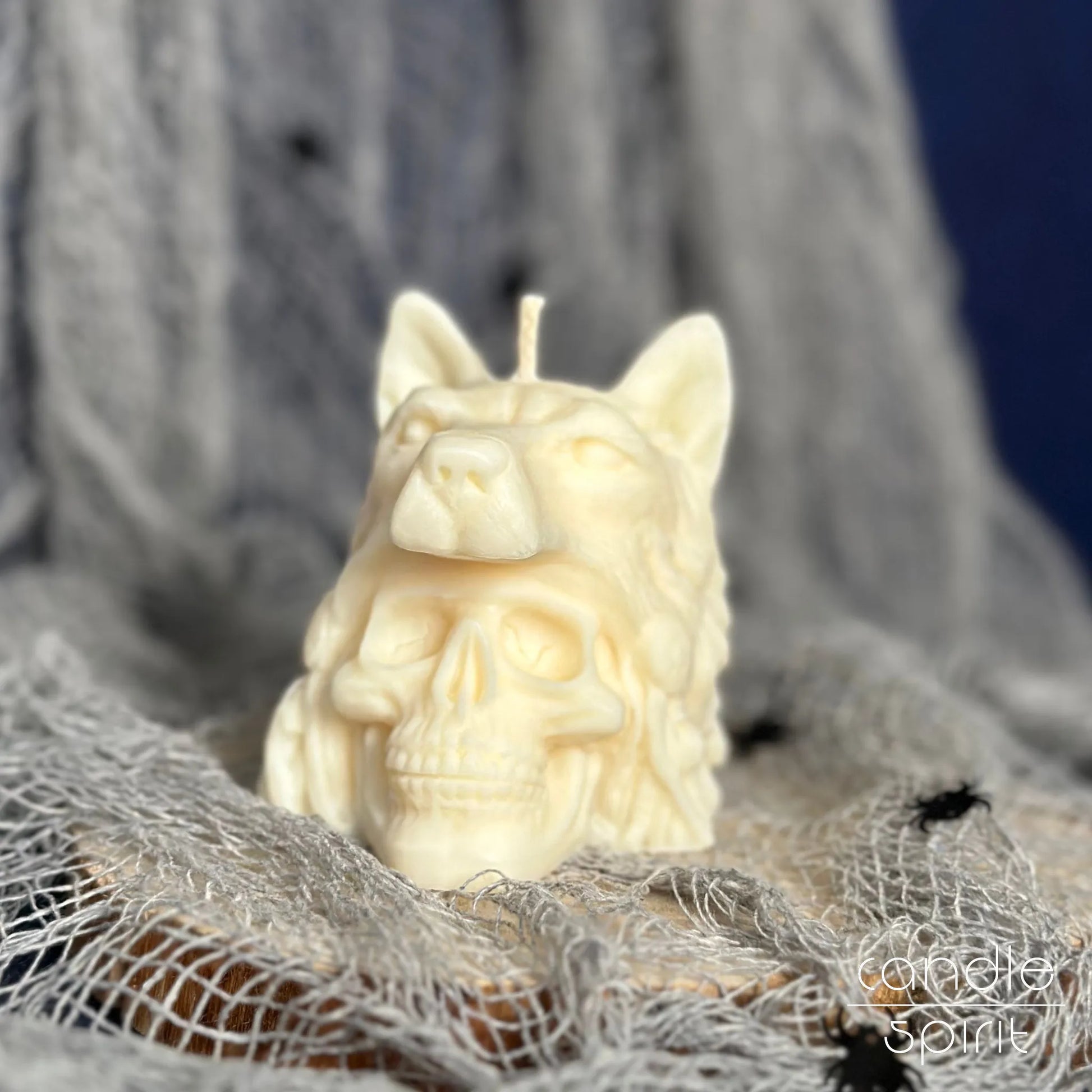 Scented white candle shaped like a human skull with a wolf on Halloween decoration - gothic birthday gift for a friend