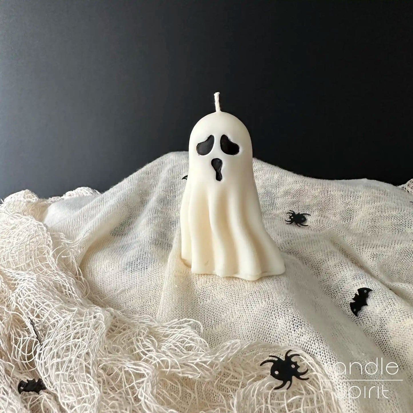 Small white ghost candle - scented Halloween party decor, spooky gift for trick-or-treaters, friends, coworkers, and kids.