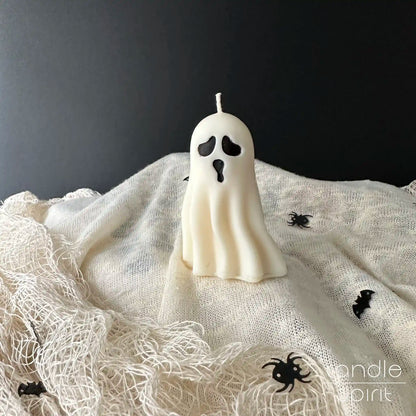 Small white ghost candle - scented Halloween party decor, spooky gift for trick-or-treaters, friends, coworkers, and kids.