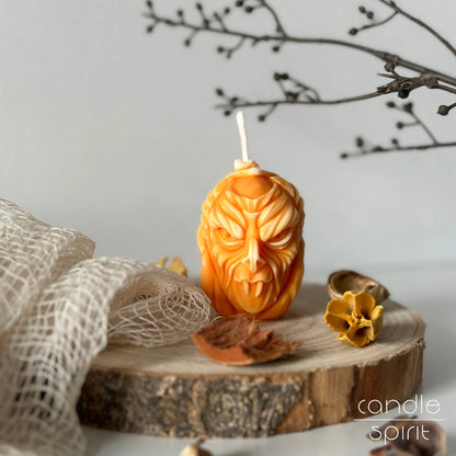 Carved pumpkin candle with a vampire face design - spooky autumn home decor. Fun Halloween gifts for kids