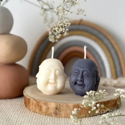 White and gray Hotei Laughing Buddha face candles - the god of happiness, fortune, and good luck in Buddhism