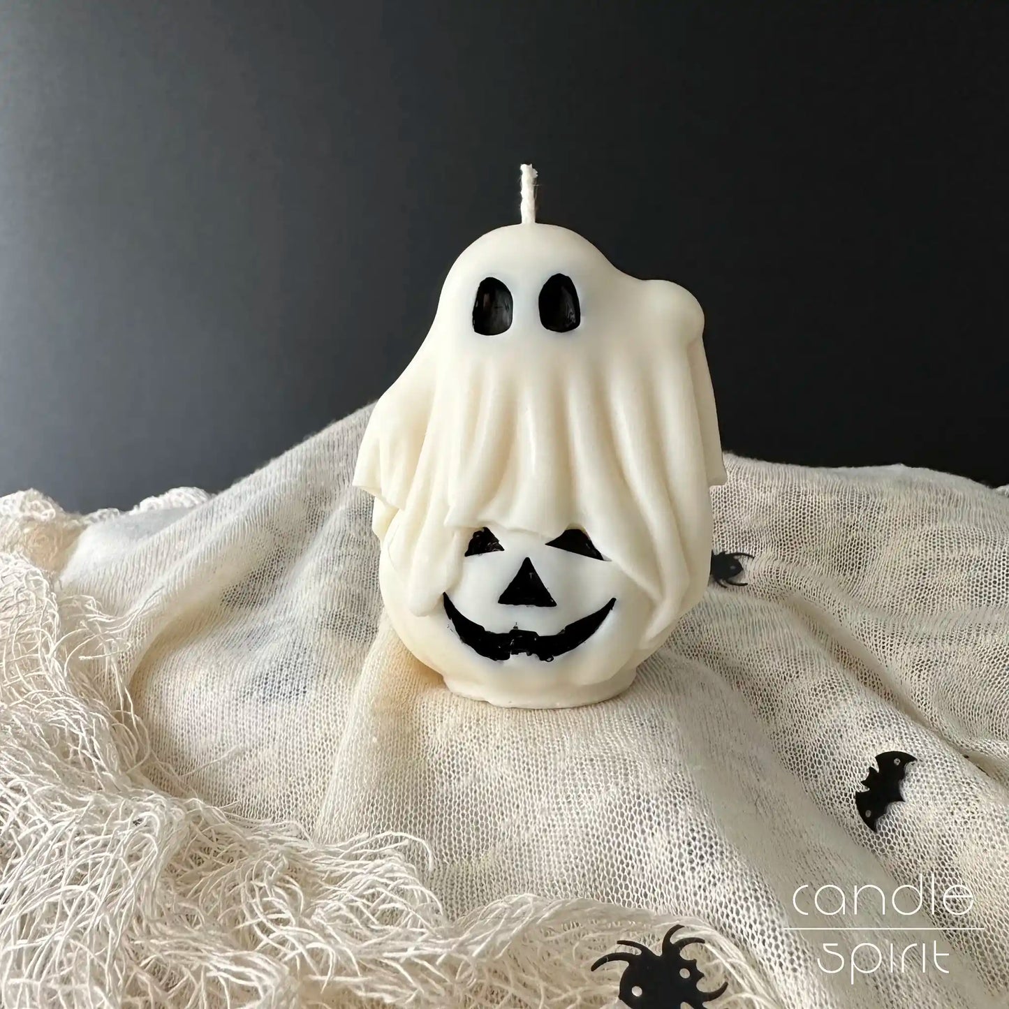White ghost candle on a pumpkin -  scented Halloween candle gift, cozy fall decor 