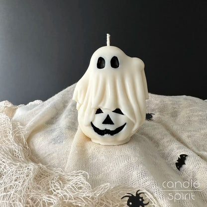 White ghost candle on a pumpkin -  scented Halloween candle gift, cozy fall decor 