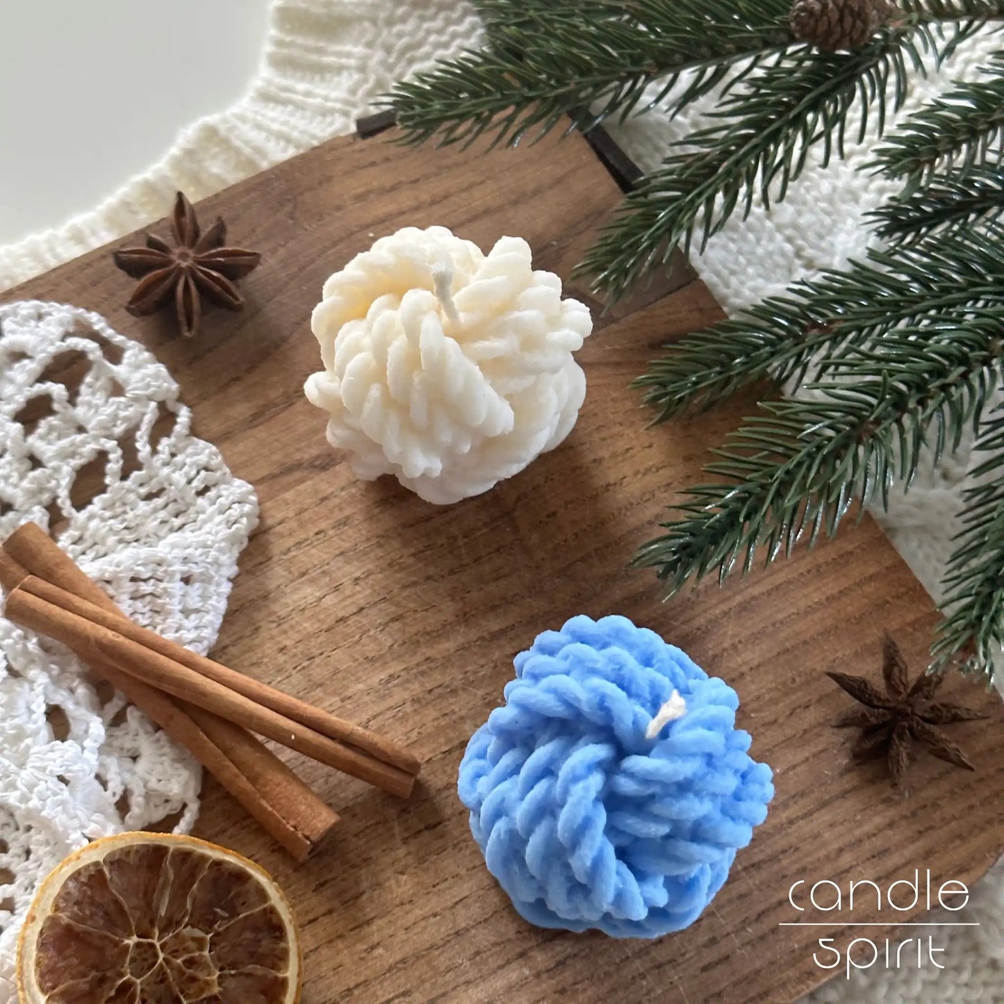 Two yarn ball candles, one white and one blue, with Christmas decorations - cozy seasonal decor and scented fall candle gift